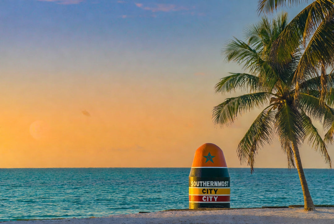 Key West's Southern Most Point Buoy on a beach.