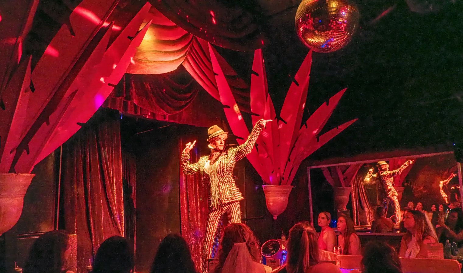 An entertainer on the stage at 801 Bourbon Bar